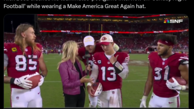 Football players on the field during a postgame interview; one wears a red cap while others, including an NFL reporter, stand nearby. Amidst them is Nick Bosa of the San Francisco 49ers, sharing insights on the game.