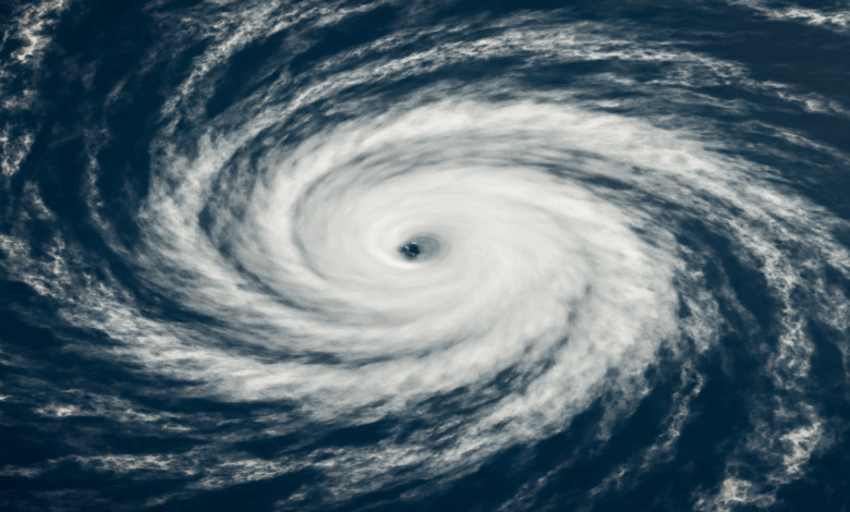 A swirling hurricane with a well-defined eye seen from space, representing Hurricane Erin over the Atlantic Ocean.