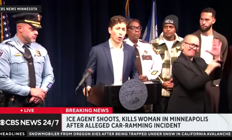 A televised press conference shows Minneapolis city officials at a podium as local law enforcement and community members stand behind, with a news chyron reporting that an ICE agent shot and killed a woman in an alleged car‑ramming incident in Minneapolis.