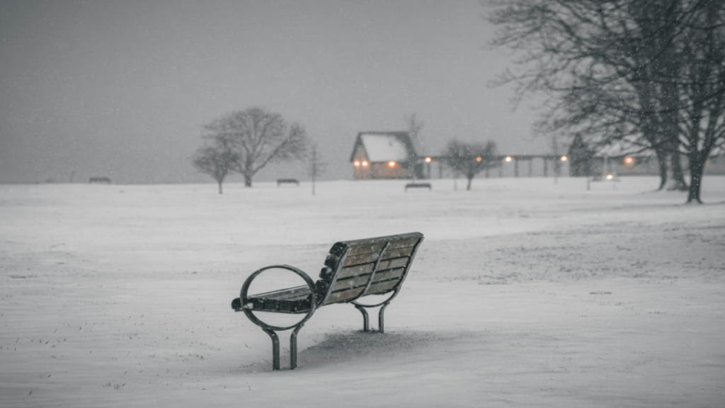 Snow-covered park bench in quiet winter landscape during Winter Storm Fern Atlanta, January 26, 2026—evoking empty streets and MARTA transit suspension amid ice and isolation
