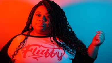 Brittany Washington, founder of Black‑owned plus‑size fashion brand My Beautiful Fluff, smiling in a colorful outfit that celebrates body positivity.