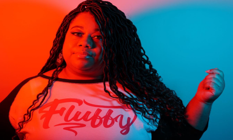 Brittany Washington, founder of Black‑owned plus‑size fashion brand My Beautiful Fluff, smiling in a colorful outfit that celebrates body positivity.